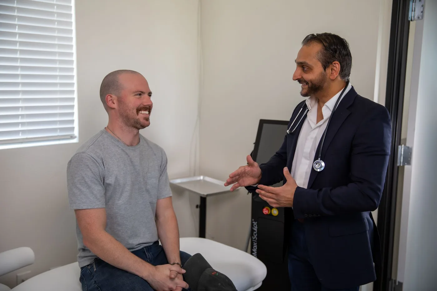 Dr. Bhavesh Patel talking with a patient in the Rx2BFIT exam room