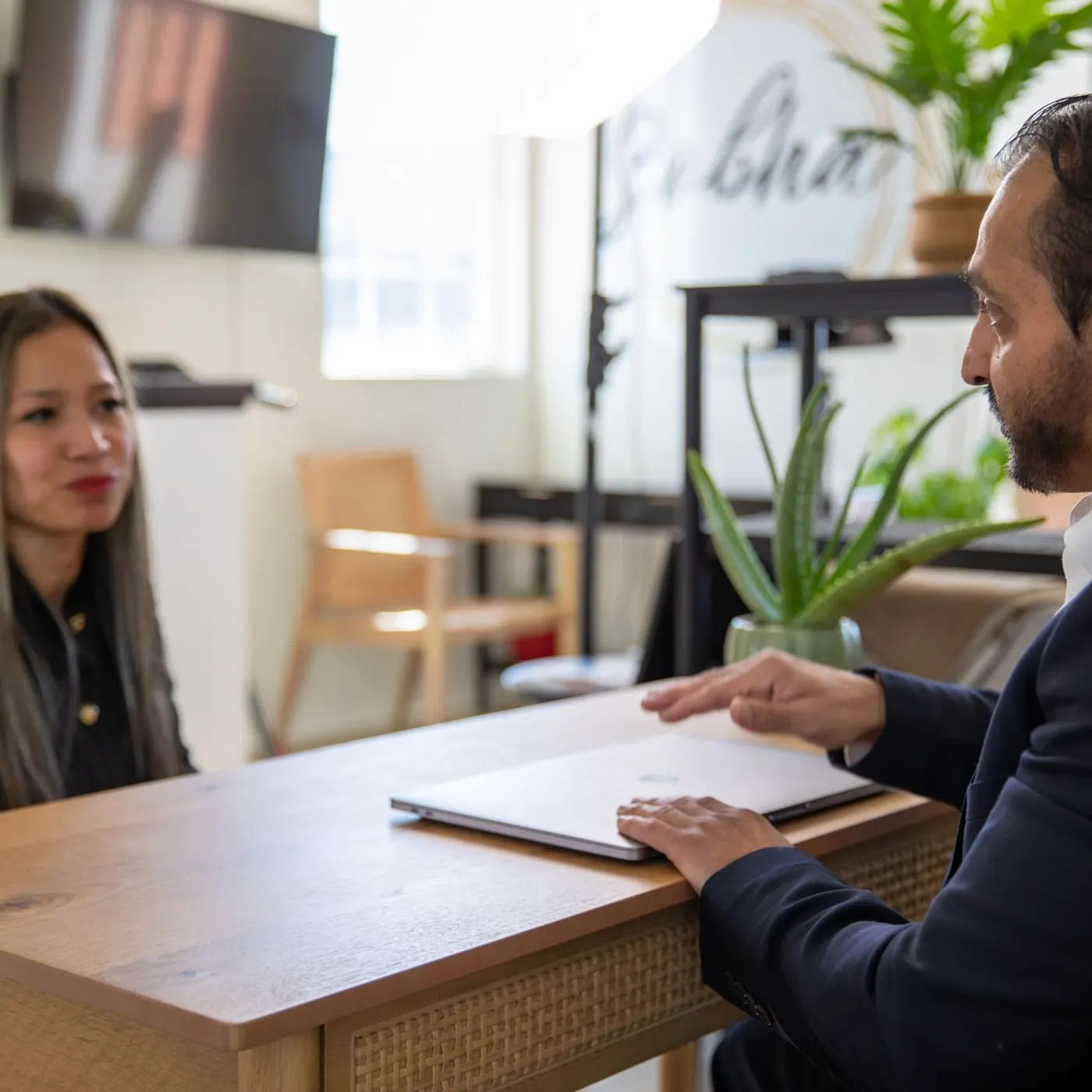 Dr. Bhavesh Patel in consultation with a patient across a desk