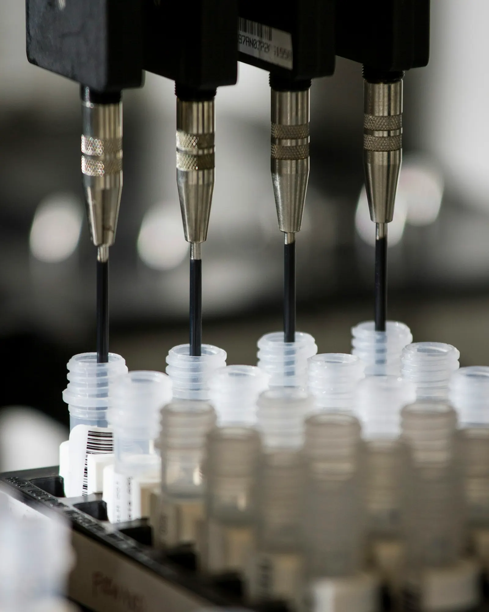 Laboratory needles dispensing liquid into small vials