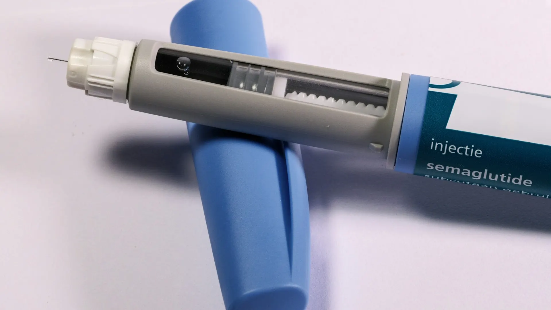 Close-up of a semaglutide injection pen with its needle exposed